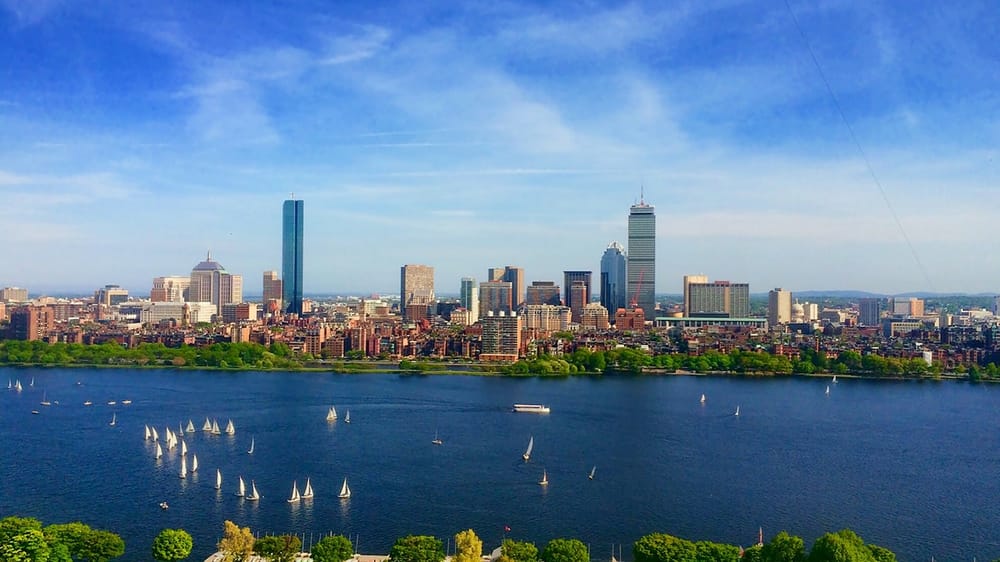 body of water near cityscape at daytime