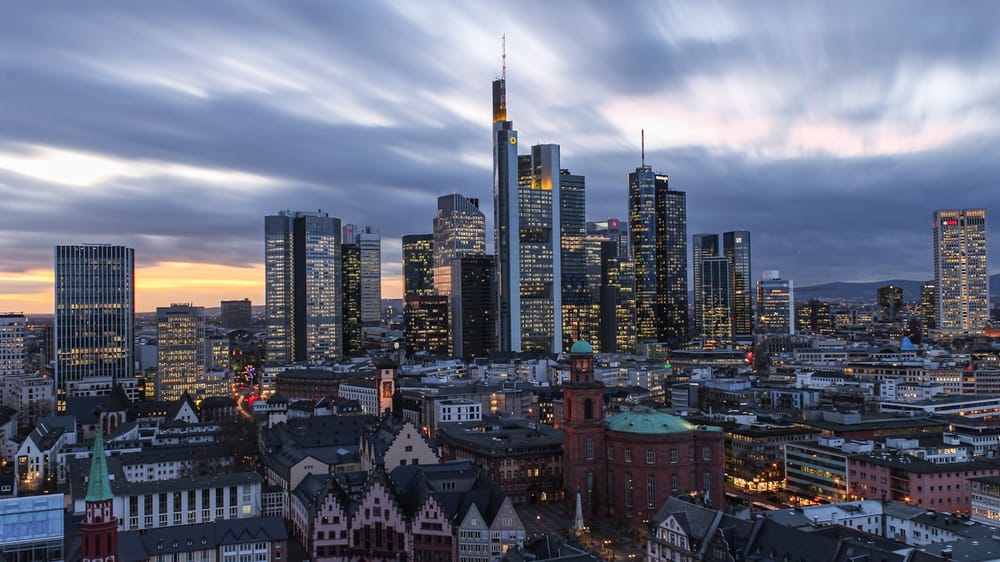 city skyline under white clouds during daytime