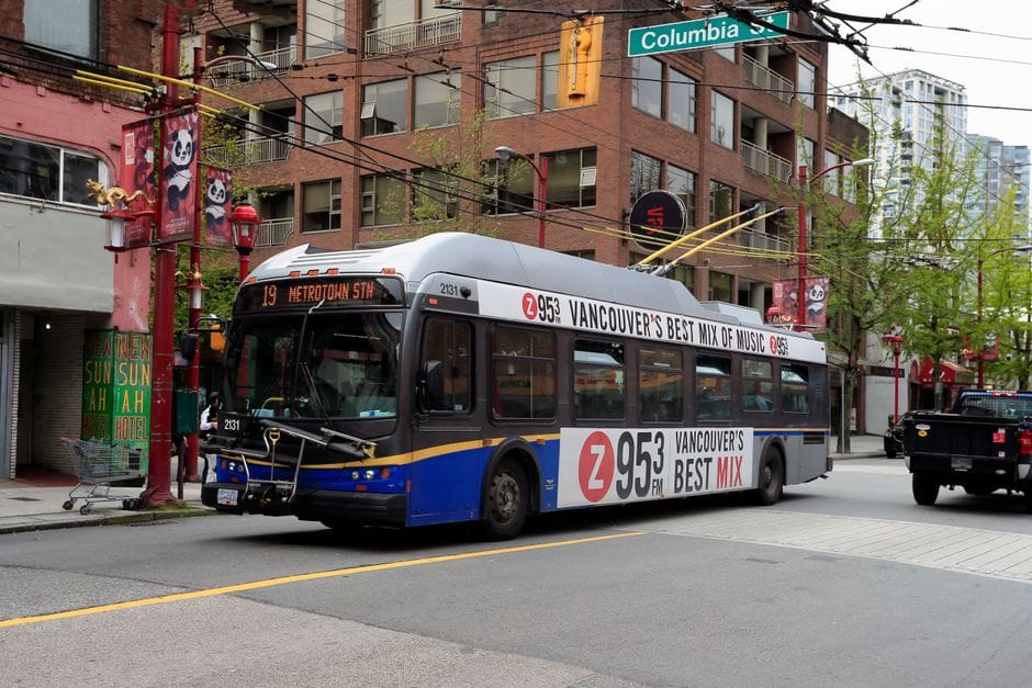 Electric bus on Columbia St in Vancouver's urban landscape, Chinatown district.