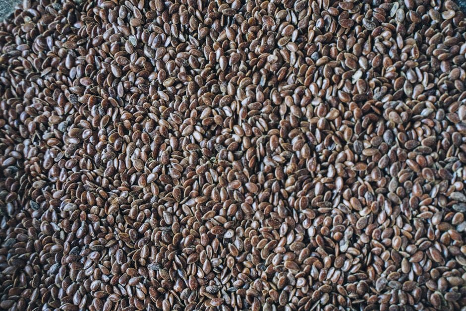 Detailed close-up shot of flax seeds, showcasing their rich brown color and texture.
