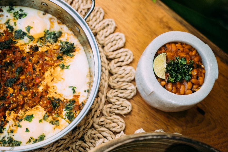 Close-up of Mexican bean dishes cooked with lime and herbs, perfect for food photography.