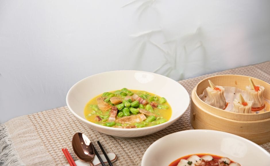 Assorted Asian dishes featuring edamame soup and steamed dumplings.