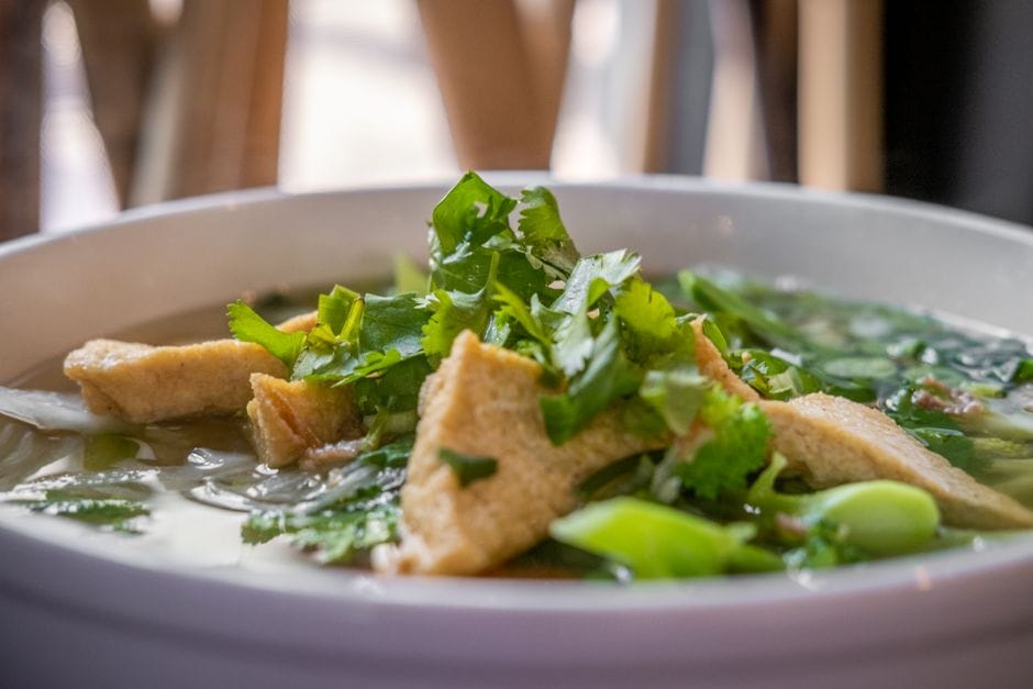 A flavorful Vietnamese soup with tofu and fresh herbs, perfect for a hearty meal.