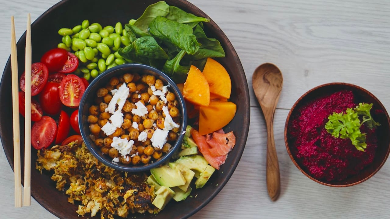 A Mediterranean grain bowl with falafel, hummus, greens, and roasted vegetables