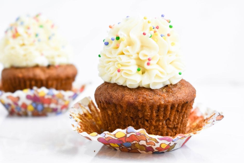 Close-up of cupcakes topped with buttercream frosting and colorful sprinkles, perfect for celebrations.